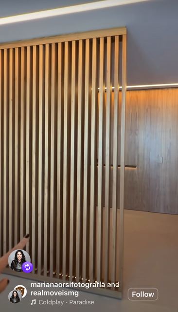 A slatted oak screen with LED light between the slats.