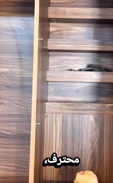 A secret compartment behind a wardrobe shelf.