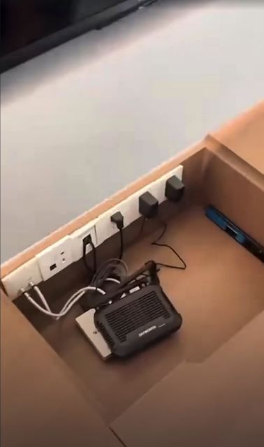 Sockets and the router hidden under a lift-up lid in the desk or TV console.