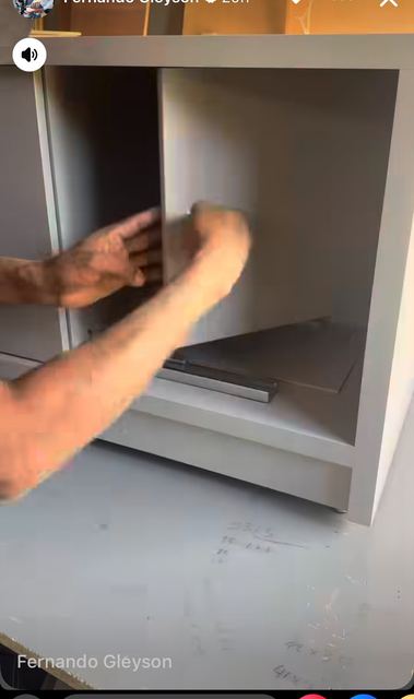 A pull-out shelf behind a flap door, in the joiner's workshop.
