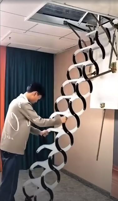 A folding loft ladder that drops from a ceiling hatch.